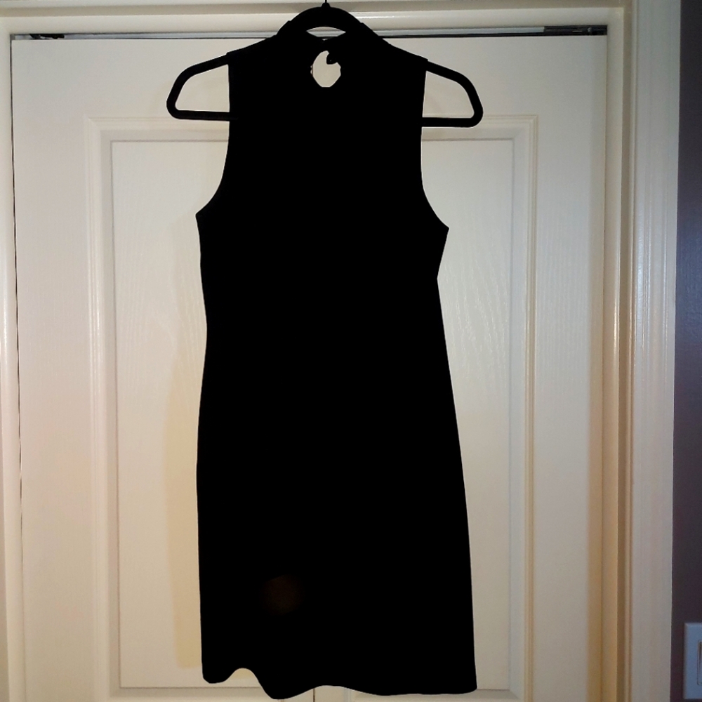 Black crepe dress. Halter neck with two button closure and back zip. Lined